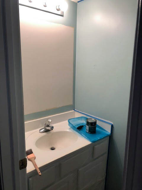 Boring builder half bath with builder grade bathroom lighting